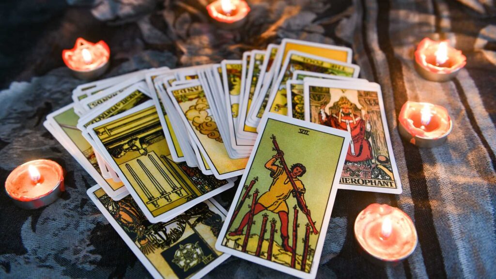 A pile of tarot cards sitting on top of a table.