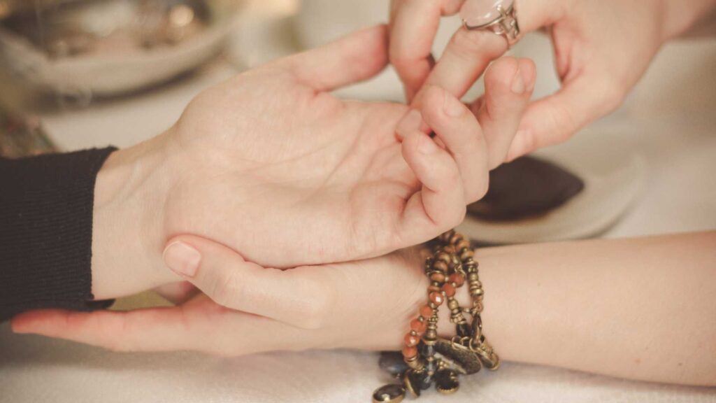 A person holding their hands with another hand