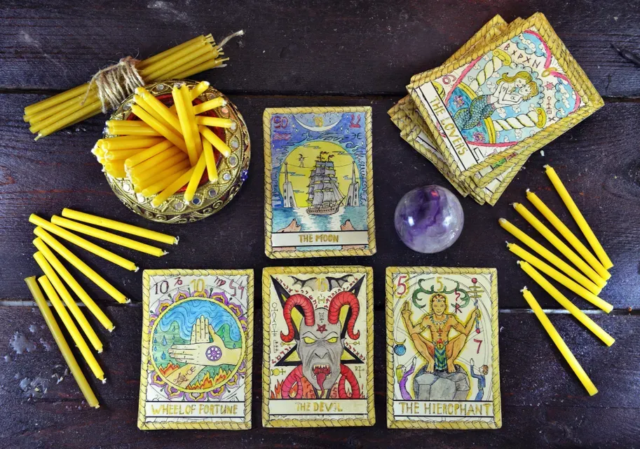 A table with tarot cards and candles on it