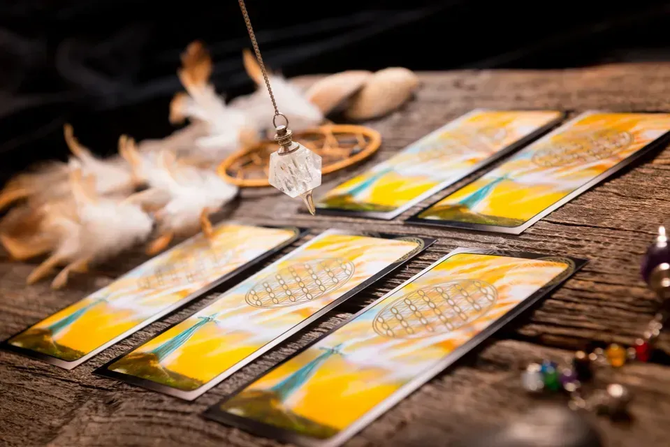 A table with tarot cards and candles on it